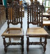 A pair of carved oak dining chairs with barley twist supports