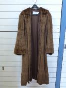 A full length brown fur coat.