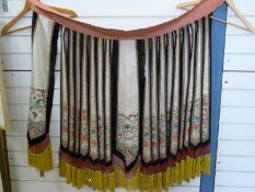 An early 20thC Chinese silk cloak made up of individual segments embroidered with chrysanthemums