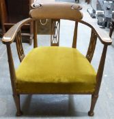 An upholstered Edwardian armchair