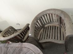 A pair of teak garden chairs