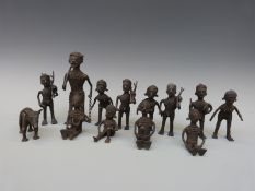 A group of thirteen African brass figures depicting hunting, mother and child,