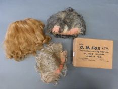 Three theatrical wigs in a box by C. H .