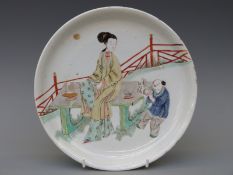 A 19thC Chinese plate with decoration of a lady and child with rabbit,