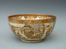 A Japanese Satsuma bowl decorated with figures to the outside and a lady playing a flute to the