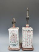 A pair of Chinese famille rose rectangular bottle vases on wooden bases decorated with deities and