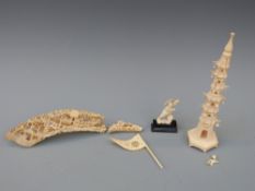 A collection of carved ivory items to incolude model of a man, flag,