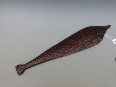 A 19thC Aboriginal wooden spear thrower with carved linear decoration to one side,