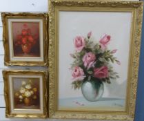 Three oil paintings of floral scenes, one of roses by E Rocca and a pair by Robert Cox,