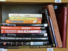 A collection of books on boxing including The Illustrated History, Fights, Boxing Greats,