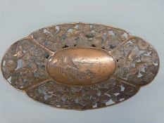 An Japanese pierced metal dish decorated with central farmyard scene surrounded by birds amongst
