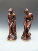 A pair of plaster bronze-effect figures of semi-nude bathing ladies after Falconnet,
