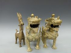 A pair of Chinese brass temple dogs together with a similar Eastern animal tallest 30cm