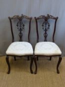 A pair of 19thC carved mahogany saloon chairs