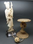 A 19thC Chinese carved ivory puzzle ball with a carved top depicting figures,