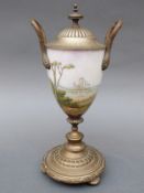 A 19thC brass mounted lidded continental Earthware lidded urn decorated with a romantic scene