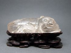 A Chinese rock crystal carving of a Dog of Fo,on rosewood stand,