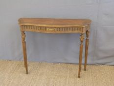 A Louis XV style console table with parquetry top, fluted legs and urn finials with ormolu mounts,