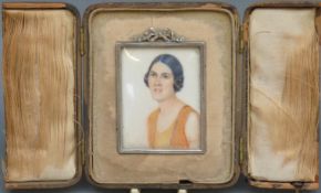 An Art Deco portrait miniature on ivory of a lady, label verso Mrs S. T Stidston No 1 by L.