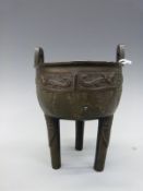 Chinese bronze ding with embossed archaic style decoration and twin handles,