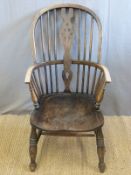 A 19thC elm seated Windsor armchair.