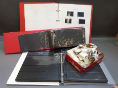 A box of empty stamp albums together with a box of loose all world stamps