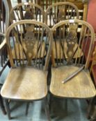 A set of four 19thC elm seated dining chairs (see lot 1552 for matching Windsor chair)