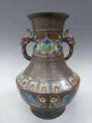 A 19thC/20thC Chinese cloisonne twin handled pedestal vase with figural mythological beast handles,