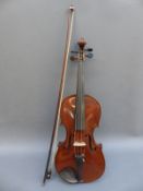A cased violin and bow with Antonius Stradivarius label by A A Schloth Saxony,