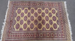A Persian rug, red geometric motif on ochre ground,