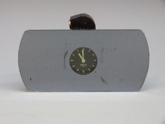 A classic or vintage car rear view mirror with inbuilt clock
