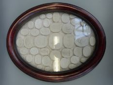 A framed and mounted display of cameos of classical scenes