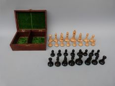 A boxed carved boxwood chess set