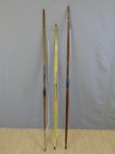 Three wooden archery bows one with layered decoration.
