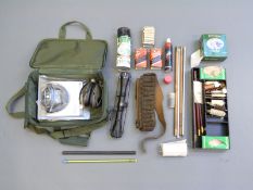 A collection of shooting and gun related items including a Hawke 4x32 scope,