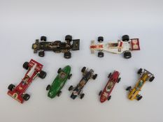 Seven Corgi Toys diecast model racing cars including Ferrari, Maserati,