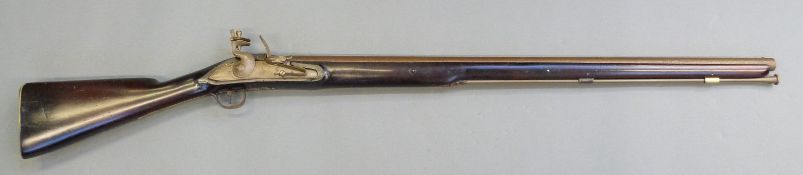 Flintlock hammer action musket with engraved Roman type lock, engraved brass trigger guard,