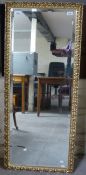 An ornate bevelled glass mirror (128 x 54cm)