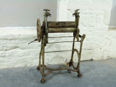 A vintage cast iron and wooden mangle