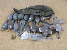 Sixteen various pigeon and duck decoys some with rotating and flapping wings, in carry bag.