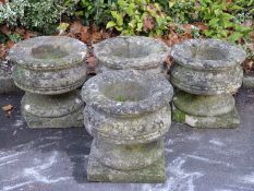 A set of four carved natural stone urns,