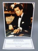 John Travolta and Pierce Brosnan signed photographs,