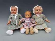 Three 1930's dolls, two cold painted with terracotta heads, one with weighted eyes,