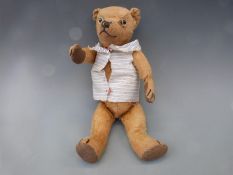 A small vintage Teddy bear with golden mohair, growler and jointed limbs,