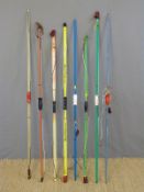 Eight fibreglass and wooden archery bows including Dunarco and Duke.