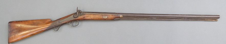 Percussion hammer action gun with engraved lock, scrolling trigger guard, brass tipped ram-rod,