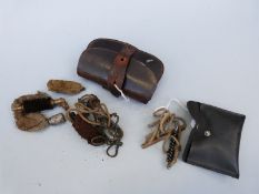 Two vintage gun cleaning kits / pull throughs, one in vintage leather case.