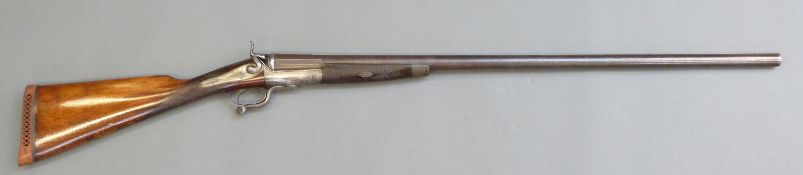 Robert S Garden of London 8 bore single barrelled hammer action shotgun with scrolling engraving to