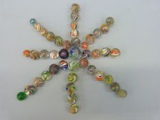 Forty three glass marbles, most with multicoloured latticino twists,