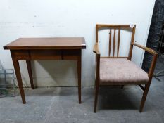 A 1960's mahogany fold over table and a Gordon Russell mahogany armchair